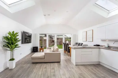 a kitchen and living room with a couch and a table at No20 Mansfield - Donnini Apartments in Prestwick