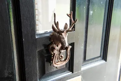 a door opener with a deer head on a window at Argyll Farmhouse-Idyllic Setting-Sleeps10 in Dunoon