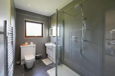 a bathroom with a shower and a toilet and a sink at Shawsmill, outside Hurlford in Hurlford