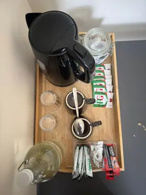 a table with a pot and a bottle of wine at Whitefield Guesthouse in Glasgow