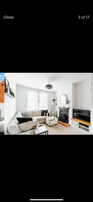 a living room with a couch and a table at Private room - Central NN1 stay in Moffat
