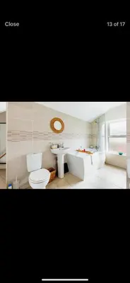 a bathroom with a toilet and a sink and a tub at Private room - Central NN1 stay in Moffat
