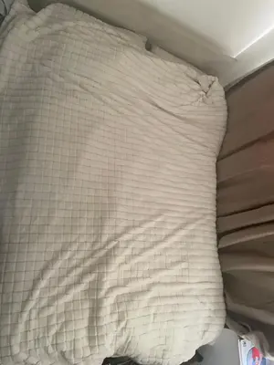 a white pillow sitting on top of a bed at Gravesend one room apartment in Moffat