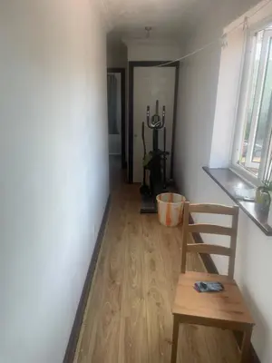 a room with a wooden table and a wooden chair at Gravesend one room apartment in Moffat
