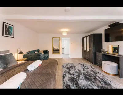 a living room with a large bed and a couch at Asentral Homes in Moffat
