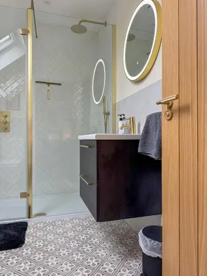 a bathroom with a shower and a sink with two mirrors at No4 Invereoch in Arrochar