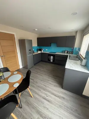 a large kitchen with a table and a table and chairs at 25 Colliers Road,Stirling