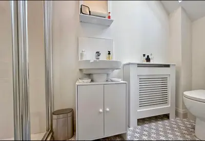 a white bathroom with a sink and a toilet at Stylish apartment in Portstewart in Moffat