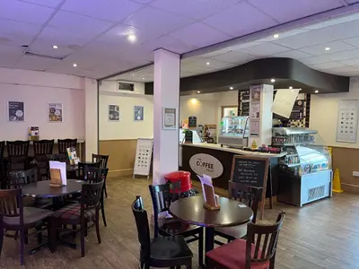 a restaurant with tables and chairs and a counter at Static Caravan in Moffat