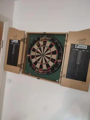 a dart board in a box with two cards at Rosebank Apartment Edinburgh City in Edinburgh