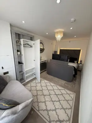 a bedroom with a bed and a couch in a room at Edinburgh city break room in Edinburgh