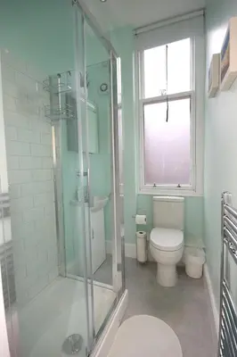 a bathroom with a shower and a toilet and a window at Hamish's Hame Edinburgh Licence No EH 69774 R Energy Rating C in Edinburgh