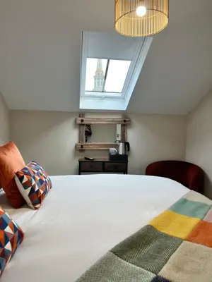a bedroom with a white bed with a window at The courtyard bar, kitchen, rooms in Falkirk