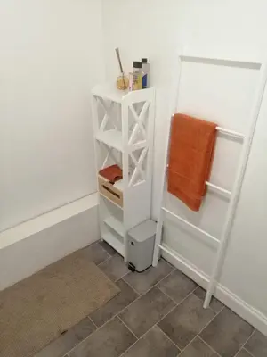 a small white cabinet in a bathroom with a towel at Castle Walk Apartment in Stirling