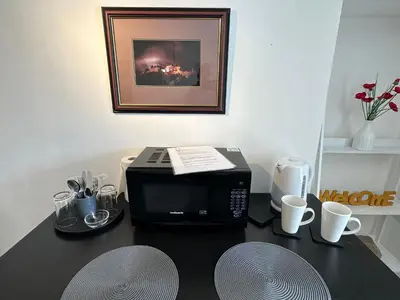 a microwave sitting on a table with at Castle Walk Apartment in Stirling