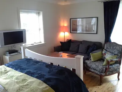 a living room with a bed and a couch at Bruach Lodge in Balloch