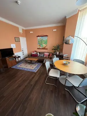 a living room with a table and a couch at Seven Sisters 1 bed apartment in Moffat