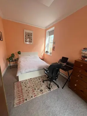 a bedroom with a bed and a desk and a chair at Seven Sisters 1 bed apartment in Moffat