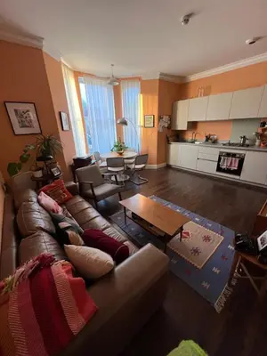 a living room with a couch and a table at Seven Sisters 1 bed apartment in Moffat