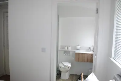 a white bathroom with a toilet and a sink at Rowardennan Rooms in the lodge Lodge no 2 in Rowardennan