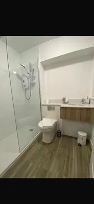 a bathroom with a toilet and a glass shower at Rowardennan Rooms in the lodge Lodge no 2 in Rowardennan