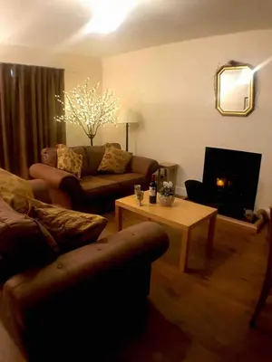a living room with a couch and a coffee table at Wood Cottage in Peebles