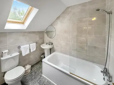 a bathroom with a tub and a toilet and a sink at Foxglove Cottage 2 - Uk50020 in Drymen