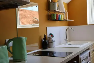 a kitchen with a sink and a stove and a window at Filey in Moffat