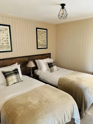 two beds in a room with twoermottermott at Breacan Lodge in Hunters Quay