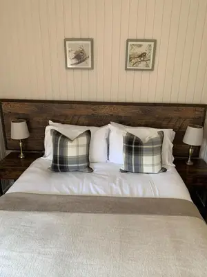a bedroom with a bed with pillows and two lamps at Breacan Lodge in Hunters Quay