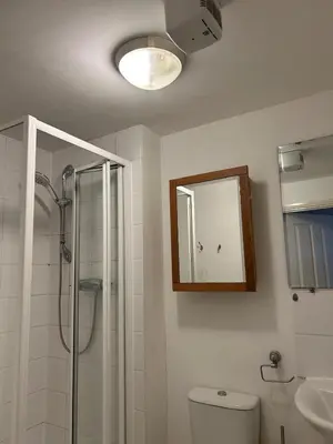 a bathroom with a shower and a toilet and a mirror at comfy residence in Moffat
