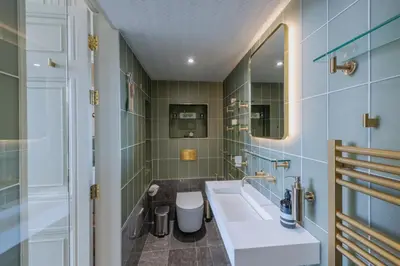 a bathroom with a white sink and a mirror at Luxury West End flat with stunning bay window views in Edinburgh