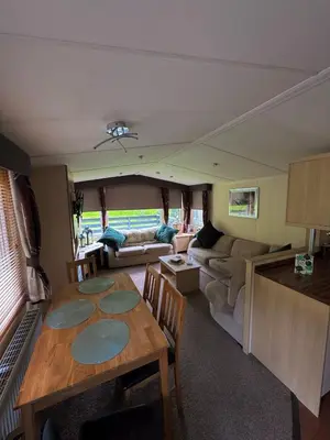 an rv living room with a table and a couch at Moselle - 6 Squirrel View in Ballantrae