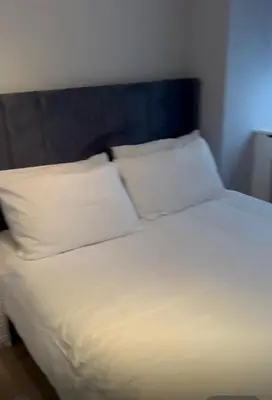 a bed with white sheets and pillows in a room at 2Bedrooms flat in knightstbridge in Moffat