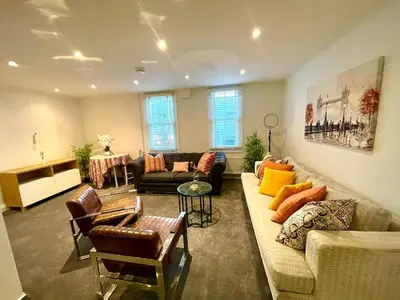 a living room with a couch and a table at Private 1 bed flat Knightsbridge, Chelsea in Moffat