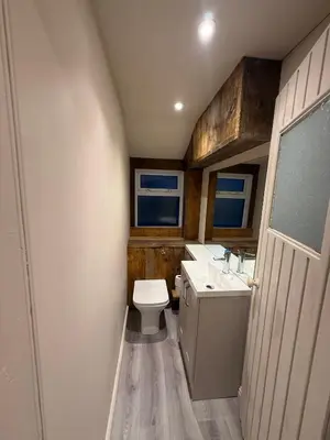 a small bathroom with a toilet and a sink at Fernbank Cottage - Bruichladdich, Isle of Islay in Bruichladdich