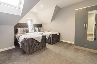 a bedroom with two beds and a window at The Loft - 3 bedroom in Crieff in Crieff
