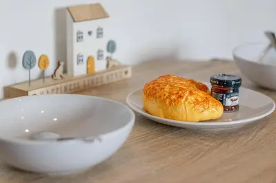 a plate with a loaf of bread on a table at The Well - 3 bedroom apartment in Motherwell
