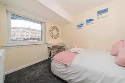 a bedroom with a bed and a window at Glasgow Apartment near Hydro & SECC, Finnieston in Glasgow