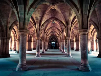 an empty hallway in a building with columns at Glasgow Apartment near Hydro & SECC, Finnieston in Glasgow
