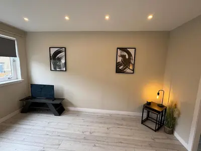 a living room with three pictures on the wall at Newly Renovated Flat Edinburgh - 2 x Double Beds in Edinburgh
