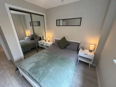a small bedroom with a bed and a mirror at Newly Renovated Flat Edinburgh - 2 x Double Beds in Edinburgh