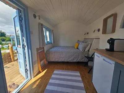 a small bedroom with a bed and a balcony at Wee Haven in Inverkeithing
