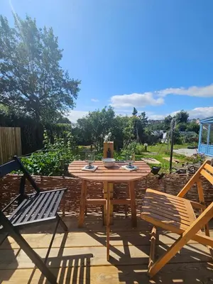 a wooden table and chairs on a patio at Wee Haven in Inverkeithing