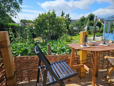 a wooden table and a chair on a patio at Wee Haven in Inverkeithing