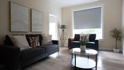 a living room with a couch and a table at Curtis Apartment in Glasgow