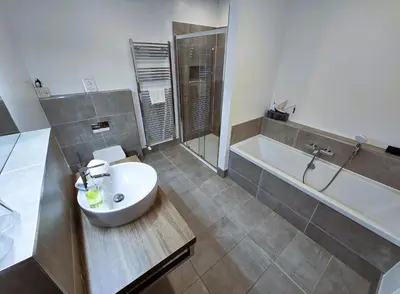 a bathroom with a sink and a tub and a toilet at Balmory Stables North, luxury stable conversion in Ascog