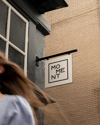 a sign on the side of a building that says no me at Moment Blythswood St in Glasgow