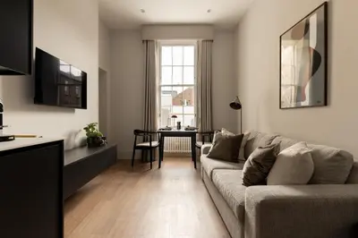a living room with a couch and a table at Moment Blythswood St in Glasgow