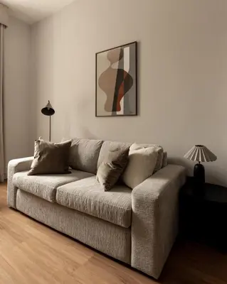 a couch in a living room with a picture on the wall at Moment Blythswood St in Glasgow